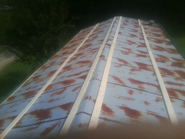 Rusted metal roof panels with new wood purlins before replacement — Storm Damage Roof Repair in Lynchburg by Roofing Brothers