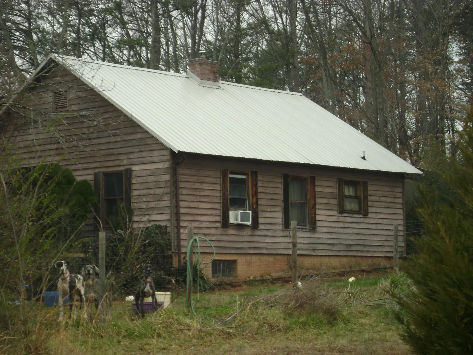 White metal roof on an old wood sided farmhouse in Lynchburg
